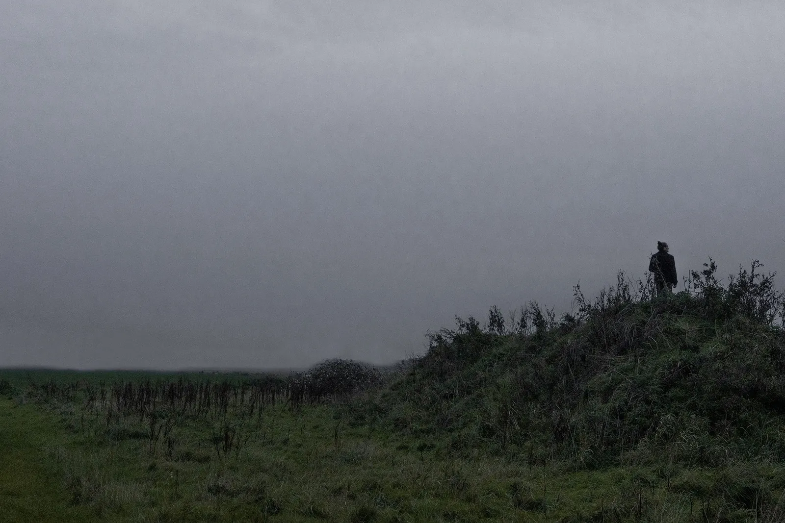 Figure on misty hillside